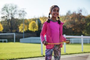 A girl with a hula hoop