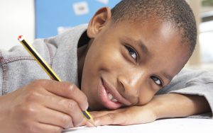 Young boy writing in school