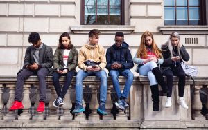Teenagers hang out on a wall