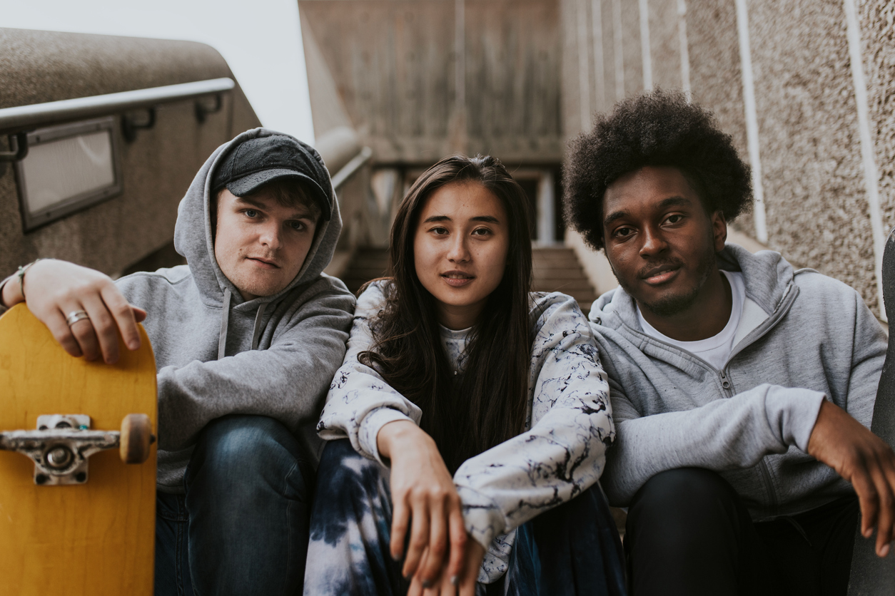 Three teenagers with skateboards
