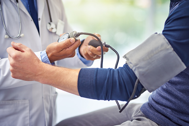 Doctor taking blood pressure of a patient