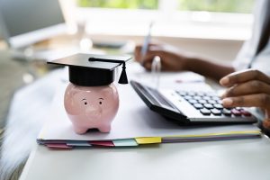 Piggy bank wearing mortarboard