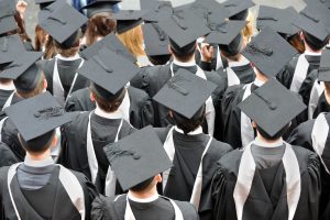 Crowd of graduates wearing mortarboards