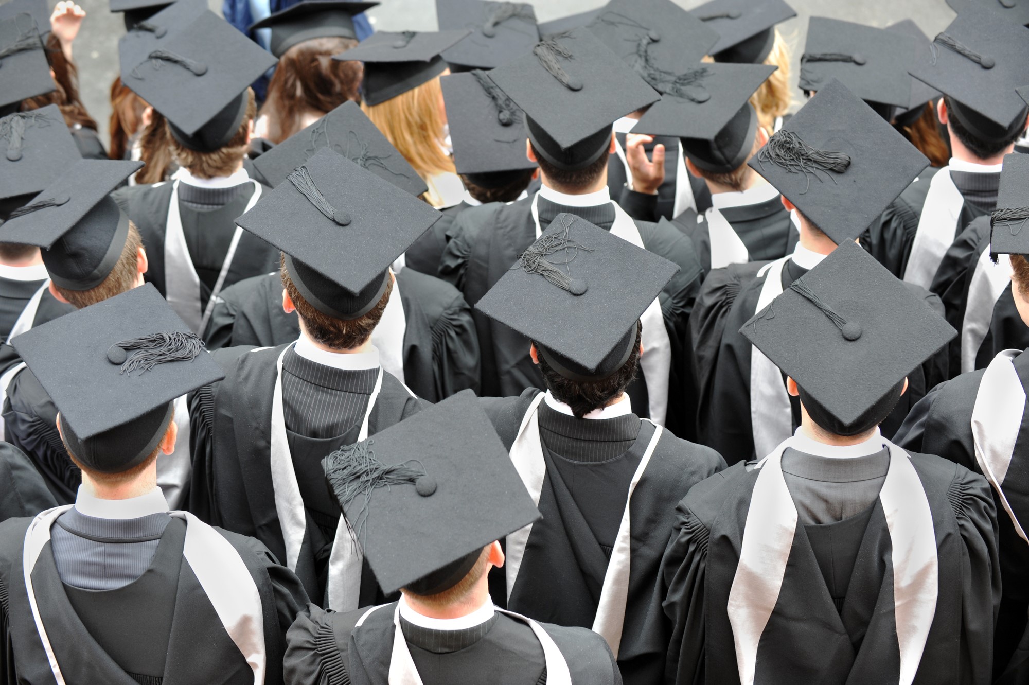 Crowd of graduates wearing mortarboards