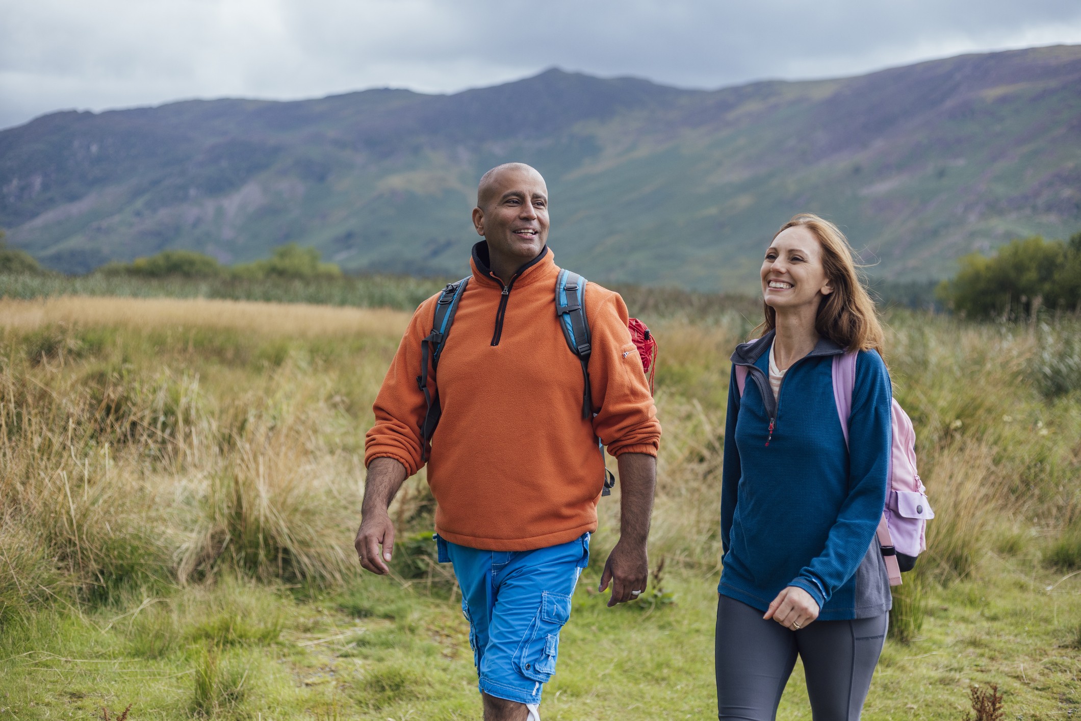 Man and woman walking in UK countryside