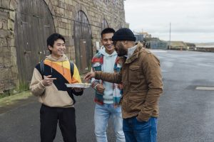 Young men eating chips