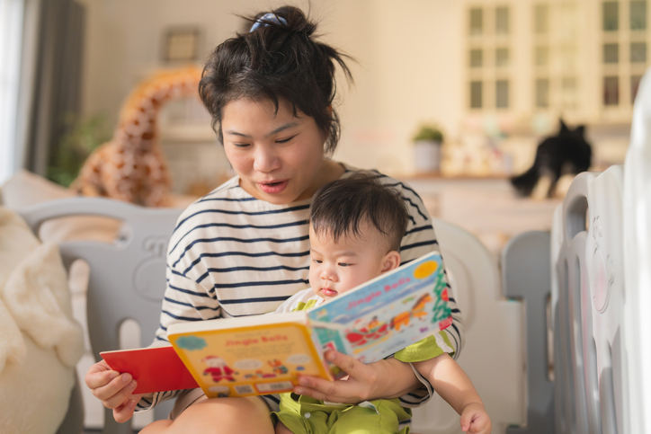 Mother reading book to baby