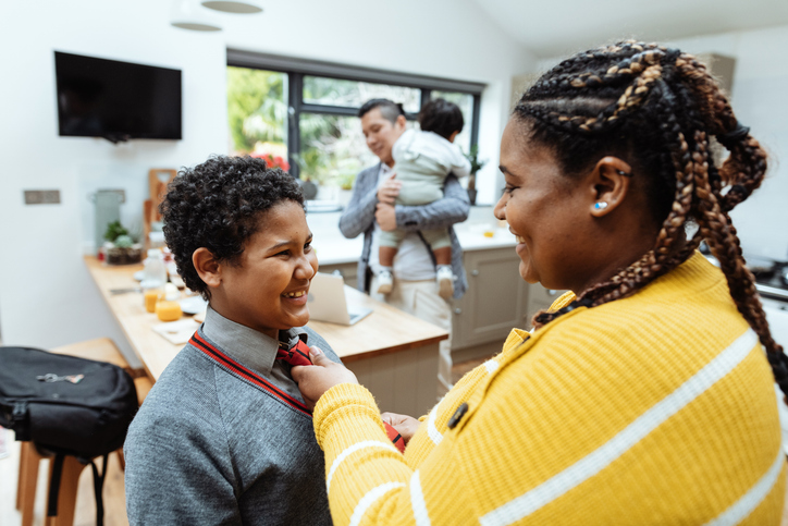 Boy and mother getting ready for school