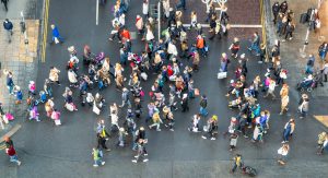 A crowd of people crossing a road