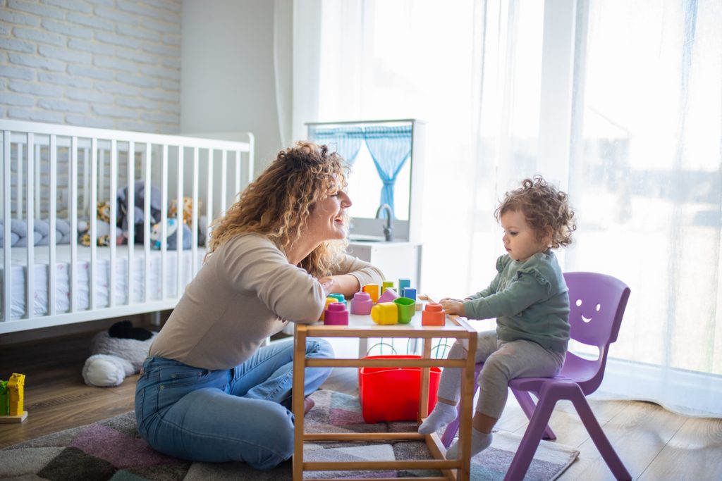 Mother and child playing with tea set