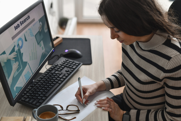 Young woman searching for work on computer