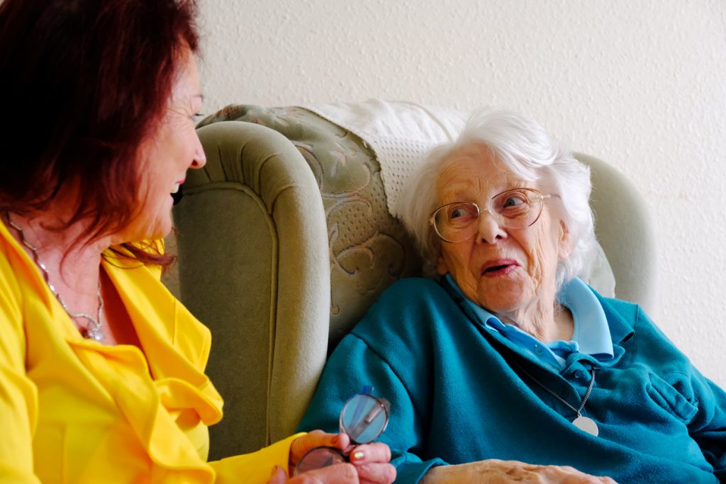 Woman caring for her elderly parent at home